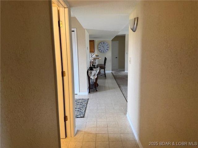 85 La Jolla Dr Unit 352-2A, Lake Ozark, MO 65049 - hall with a textured wall, light tile patterned floors, and baseboards