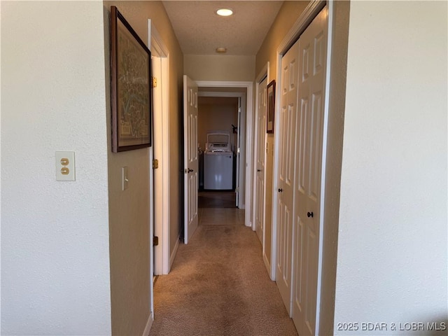 85 La Jolla Dr Unit 352-2A, Lake Ozark, MO 65049 - hallway with washer / clothes dryer, light carpet, baseboards, and recessed lighting