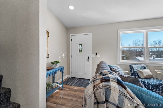 entrance foyer featuring dark wood finished floors and baseboards