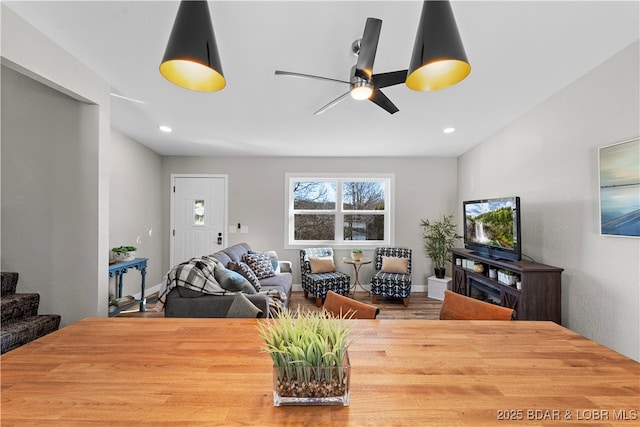 living area featuring stairs, ceiling fan, baseboards, and recessed lighting