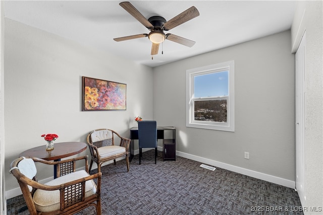 living area featuring ceiling fan, baseboards, visible vents, and dark colored carpet