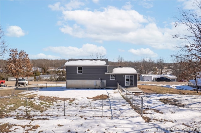 exterior space with cooling unit and fence