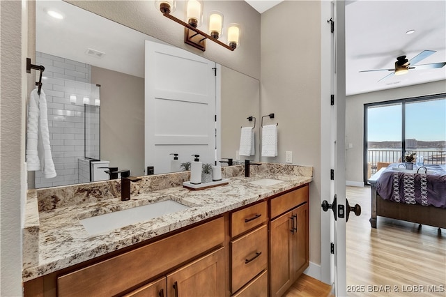 182 Vintage Dr Unit 4H, Lake Ozark, MO 65049 - ensuite bathroom with wood finished floors, a sink, ensuite bath, and double vanity