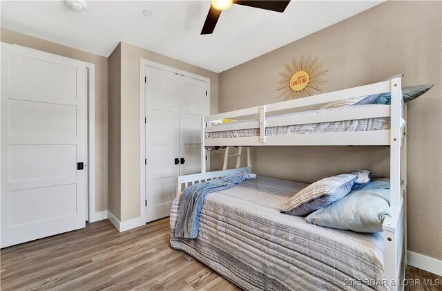 182 Vintage Dr Unit 4H, Lake Ozark, MO 65049 - bedroom featuring a closet, ceiling fan, baseboards, and wood finished floors
