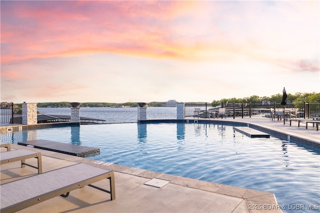 182 Vintage Dr Unit 4H, Lake Ozark, MO 65049 - pool at dusk with a water view and fence