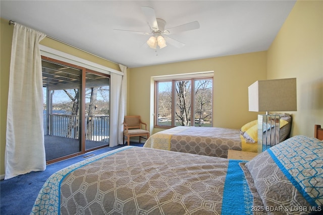 carpeted bedroom with access to outside, visible vents, and ceiling fan