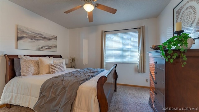 carpeted bedroom with baseboards and a ceiling fan