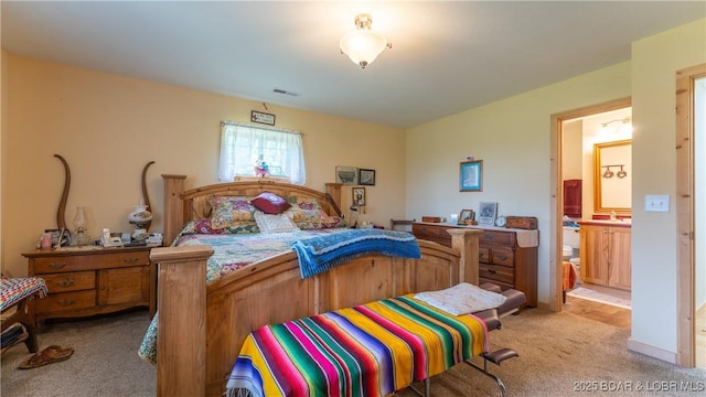 bedroom featuring visible vents and light carpet