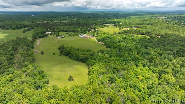 birds eye view of property with a view of trees