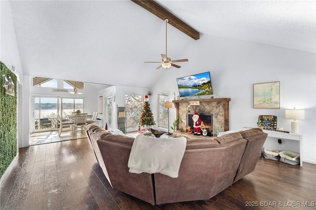 living room with beam ceiling, high vaulted ceiling, dark wood-style flooring, and a stone fireplace