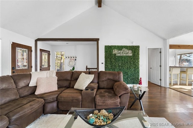 living room featuring a healthy amount of sunlight, high vaulted ceiling, wood finished floors, and beamed ceiling