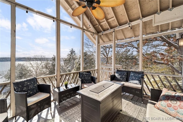 sunroom / solarium featuring ceiling fan, lofted ceiling, and wood ceiling