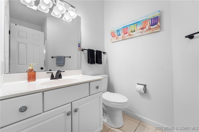 bathroom with baseboards, vanity, toilet, and tile patterned floors