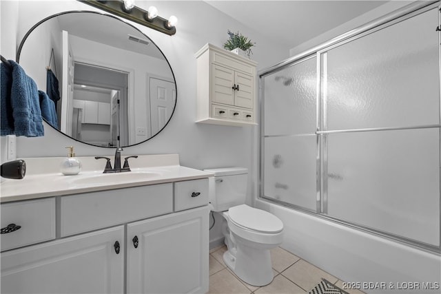 full bath featuring visible vents, toilet, enclosed tub / shower combo, vanity, and tile patterned floors