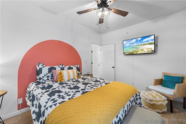 bedroom with baseboards, a ceiling fan, and wood finished floors