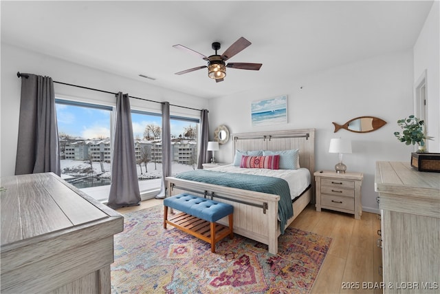 bedroom featuring ceiling fan, access to outside, visible vents, and light wood-style floors