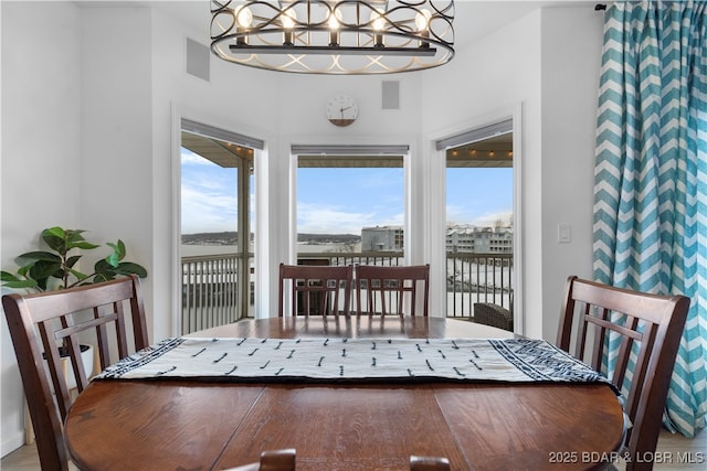 dining room featuring visible vents and a notable chandelier