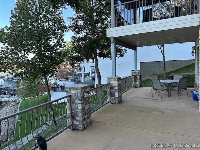 view of patio / terrace featuring outdoor dining space and a balcony