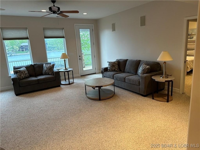 carpeted living room featuring recessed lighting, visible vents, and baseboards