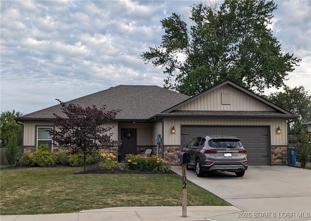 view of front of property featuring a garage, stone siding, driveway, roof with shingles, and a front lawn