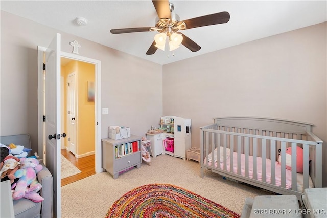 bedroom with a ceiling fan and light colored carpet