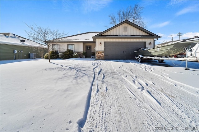 ranch-style home with an attached garage, stone siding, and central AC