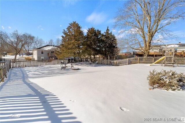 snowy yard featuring fence