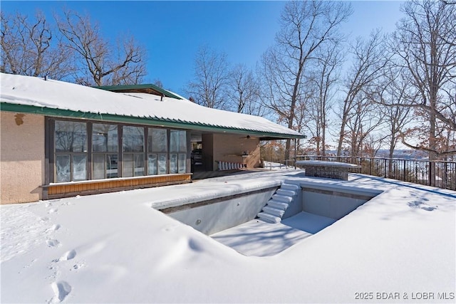 snow covered pool featuring fence