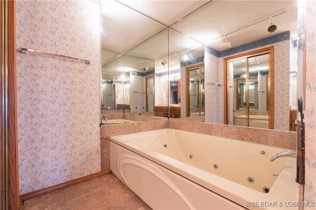 full bathroom featuring vanity, baseboards, tile patterned floors, a whirlpool tub, and wallpapered walls