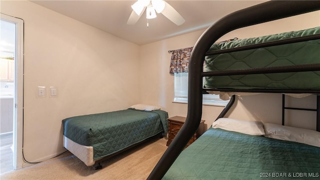 carpeted bedroom with multiple windows and ceiling fan