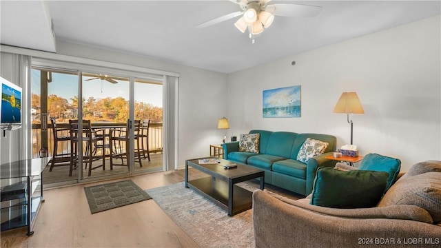 living area with a ceiling fan and light wood-style flooring