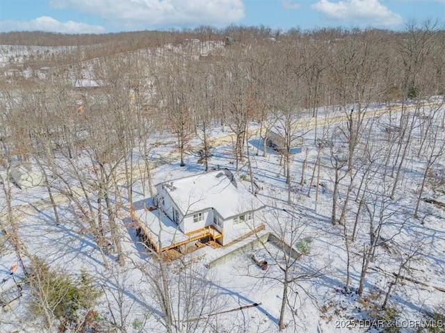 snowy aerial view with a forest view