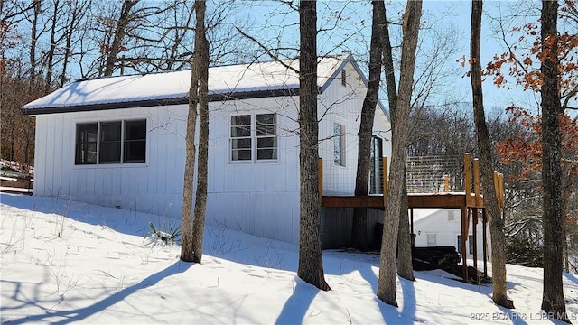 view of snow covered exterior with a wooden deck