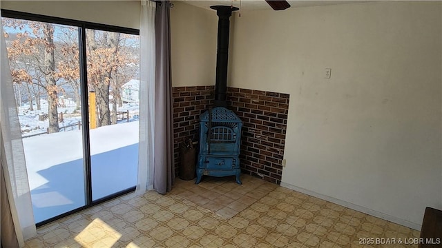 interior space featuring a wood stove and tile patterned floors