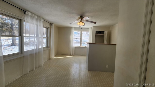 spare room with a textured ceiling and ceiling fan