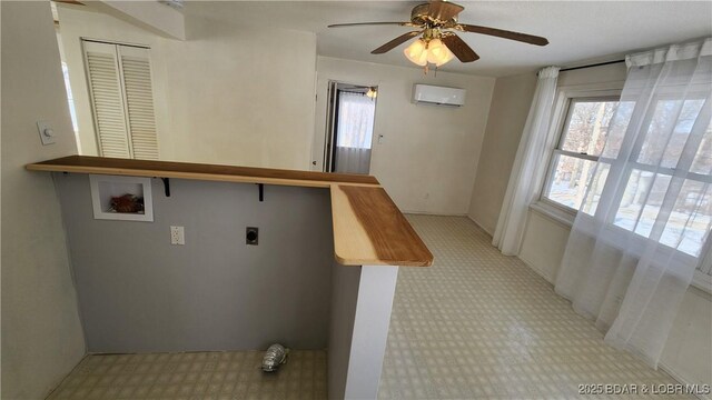 26666 Burton Rd, Barnett, MO 65011 - laundry room with electric dryer hookup, washer hookup, ceiling fan, an AC wall unit, and light carpet