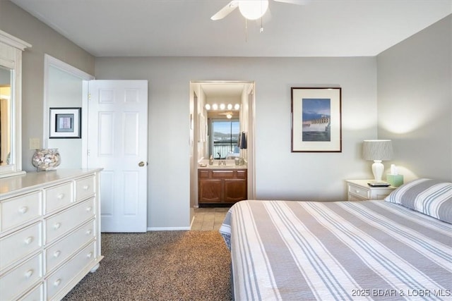 bedroom featuring light colored carpet, a ceiling fan, connected bathroom, and baseboards