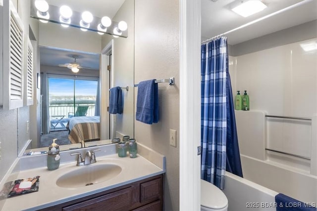 ensuite bathroom featuring toilet, a ceiling fan, shower / tub combo, connected bathroom, and vanity