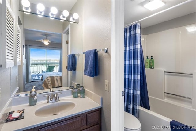 ensuite bathroom featuring vanity, shower / tub combo with curtain, a textured wall, toilet, and ensuite bath