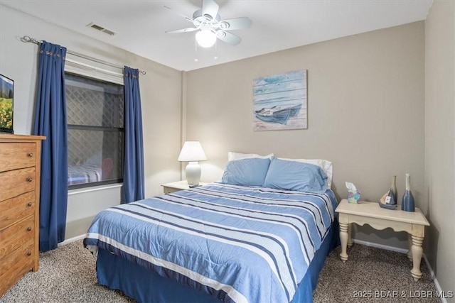 carpeted bedroom featuring ceiling fan, visible vents, and baseboards