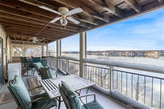 snow covered back of property featuring a bar and ceiling fan