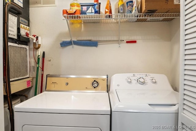 washroom with laundry area and washing machine and dryer