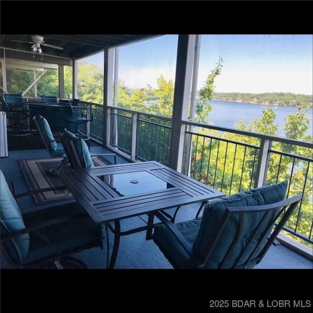exterior space featuring a water view, ceiling fan, and a wealth of natural light