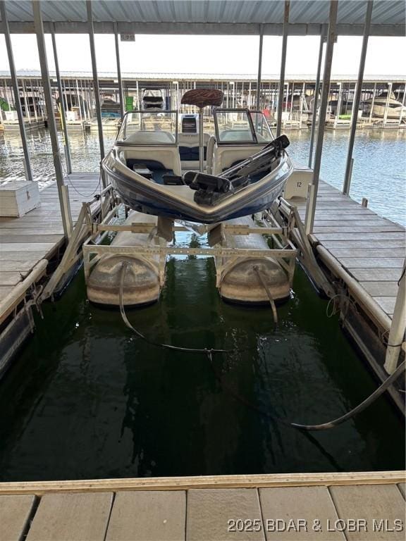 view of dock with boat lift and a water view