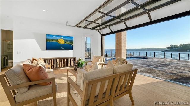 interior space featuring a water view, an outdoor hangout area, and a pergola