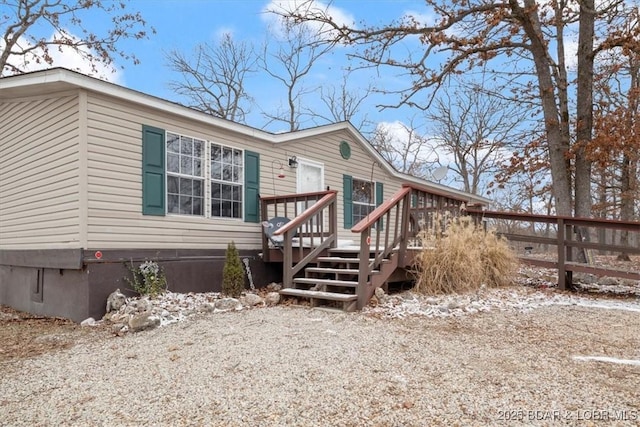 view of front facade with a wooden deck