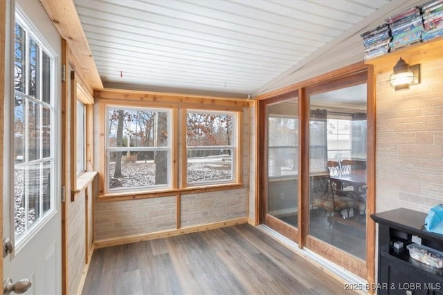 unfurnished sunroom featuring vaulted ceiling