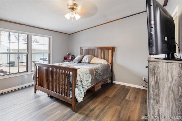 bedroom with ornamental molding, baseboards, and wood finished floors