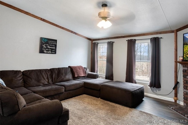 living room with lofted ceiling, a brick fireplace, crown molding, and wood finished floors