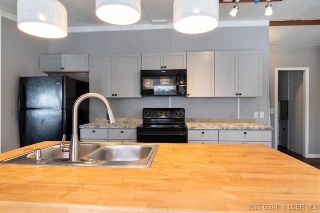 kitchen featuring ornamental molding, a sink, and black appliances